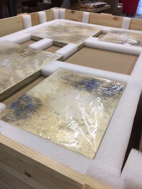 Multiple paintings individually wrapped and securely packed in a crate for shipment by expert Goodman art handlers.